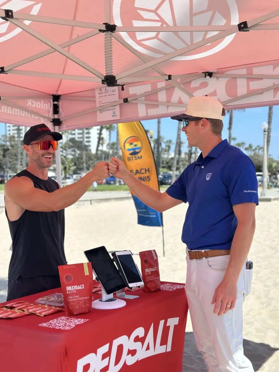 Jacob meeting a visitor at a REDSALT event booth