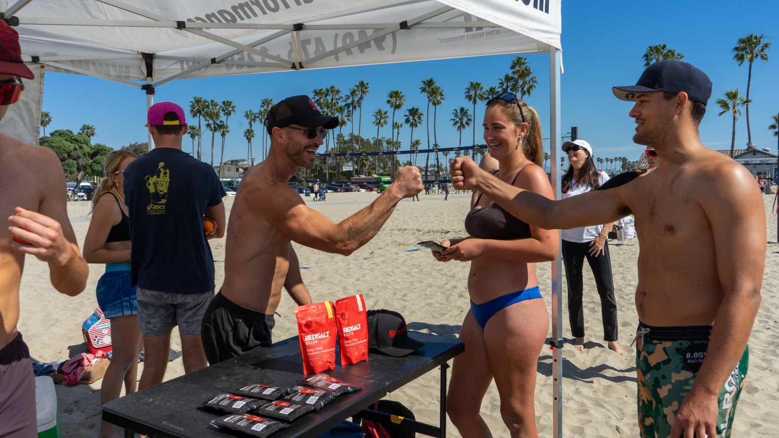 Jacob Gise with athletes at a REDSALT beach event